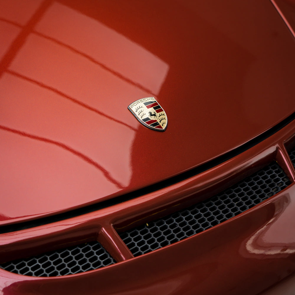Porsche wrapped in Glossy Metallic Cherry Red vinyl wrap.